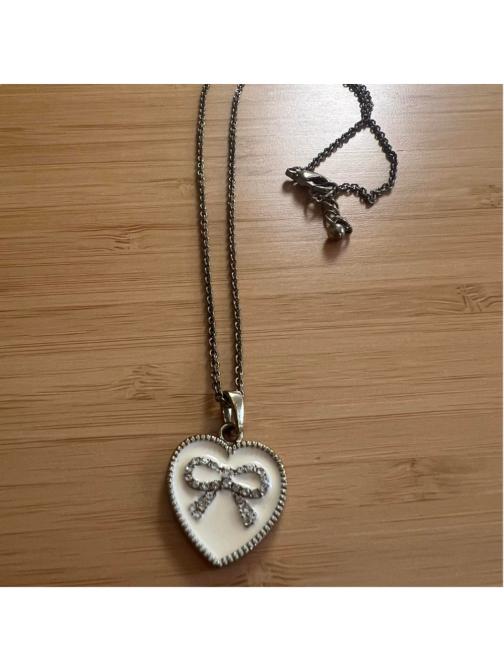 Gold heart necklace with bow design